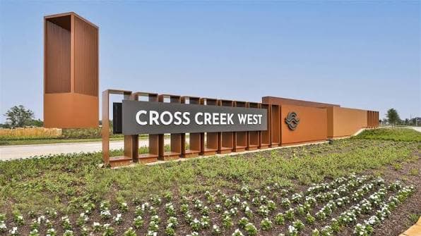 Cross Creek West community entrance monument sign with a modern brick-toned design