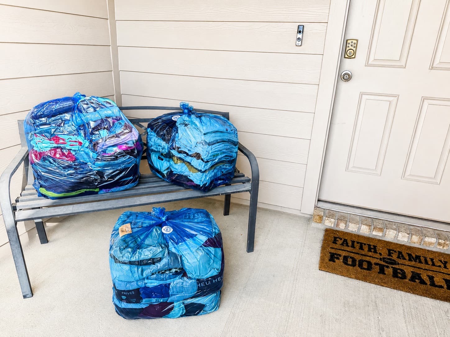 Bagged laundry ready for pickup on a porch bench in Katy, TX