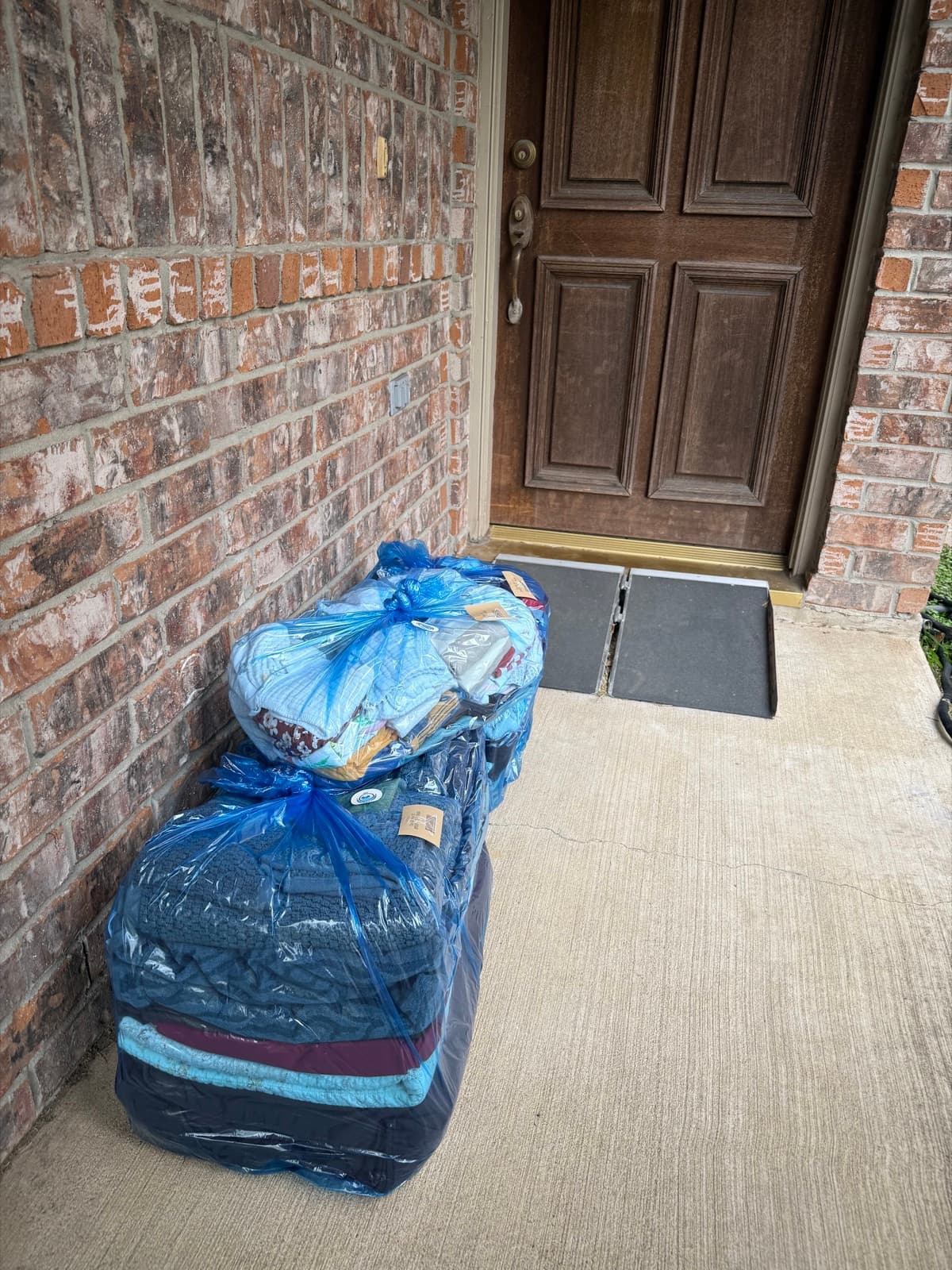 Tagged laundry bags ready for pickup outside a customer's home