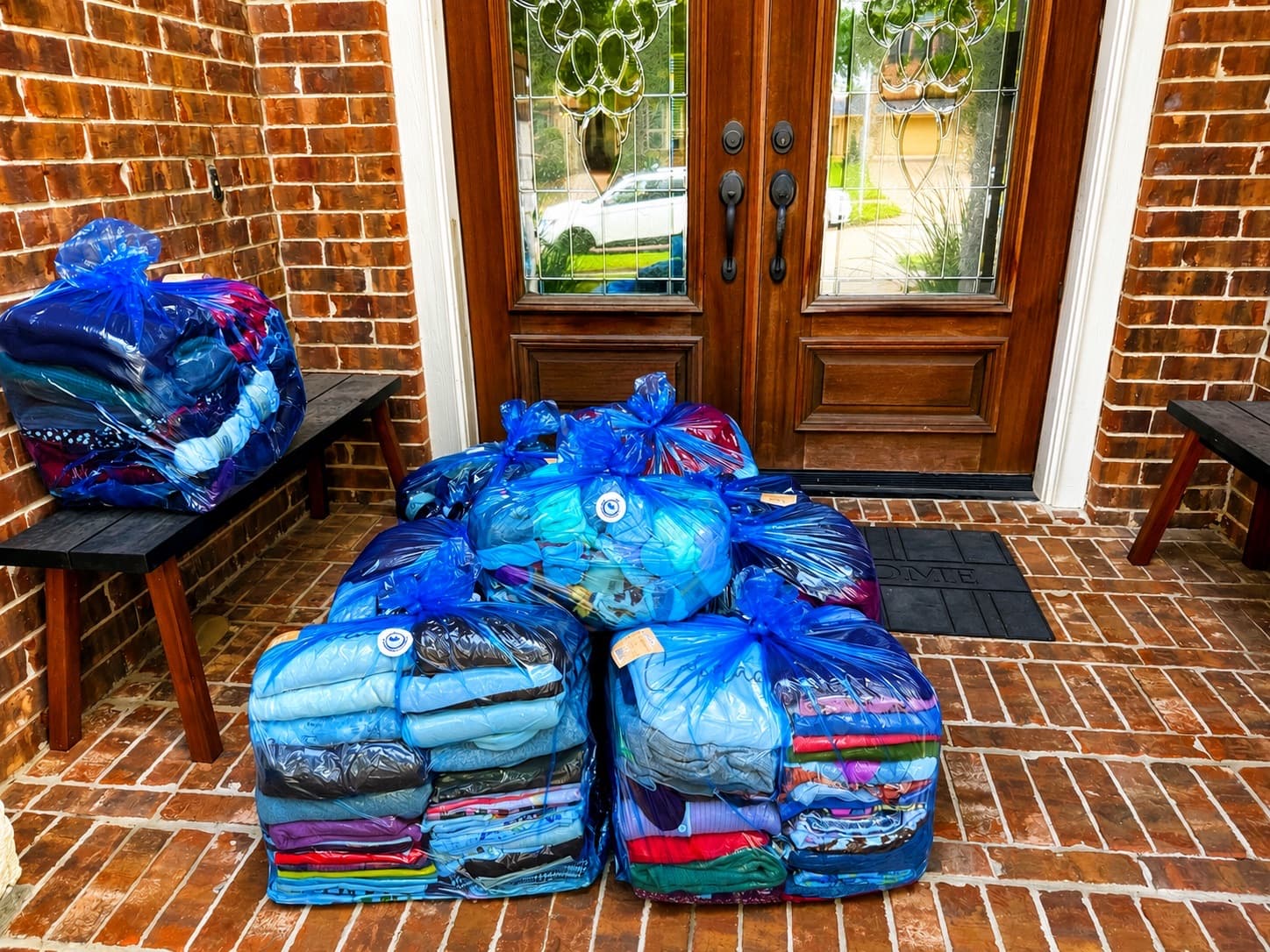 Bagged laundry ready for pickup at a Fulshear-area front door