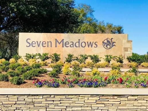 Seven Meadows community entrance monument sign surrounded by landscaping