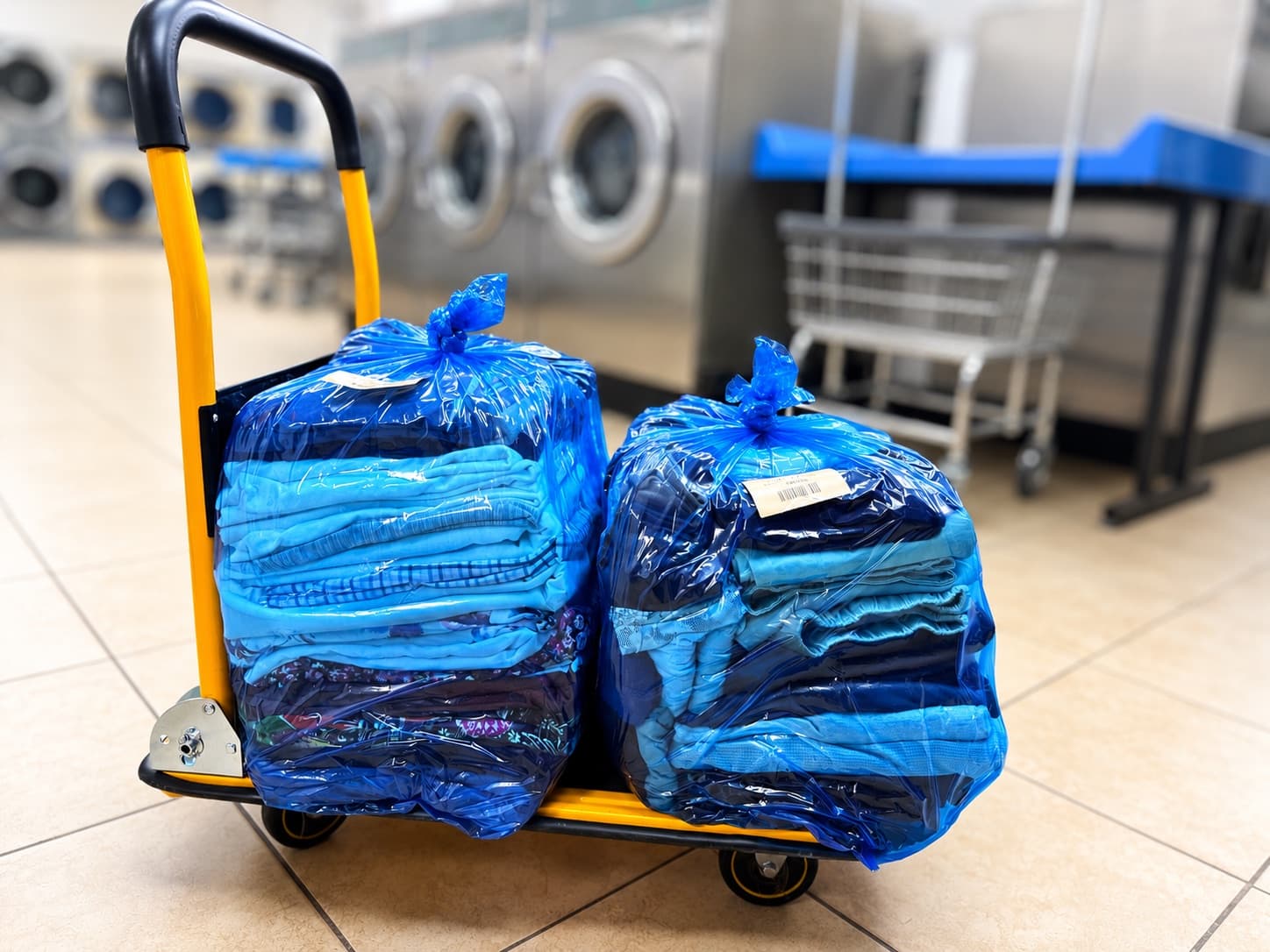 Finished commercial orders bagged and ready on a delivery cart