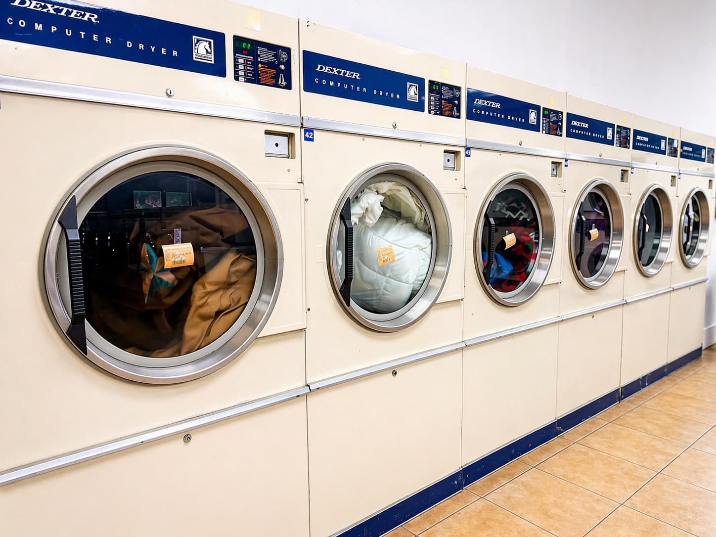 Dexter commercial dryers running a bulk load of linens