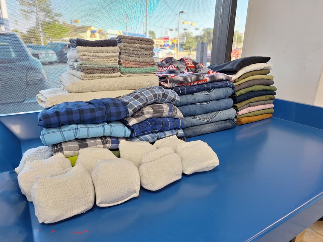 Assorted folded towels and linens organized on the folding table