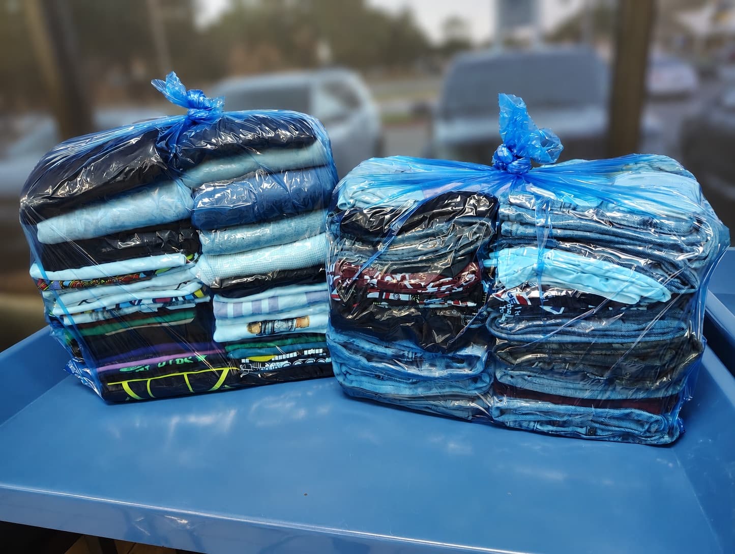 Two wrapped and tied wash & fold orders ready for customer pickup