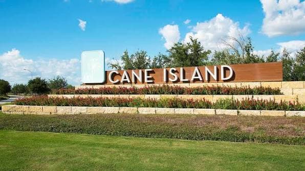 Cane Island community entrance monument sign surrounded by landscaping