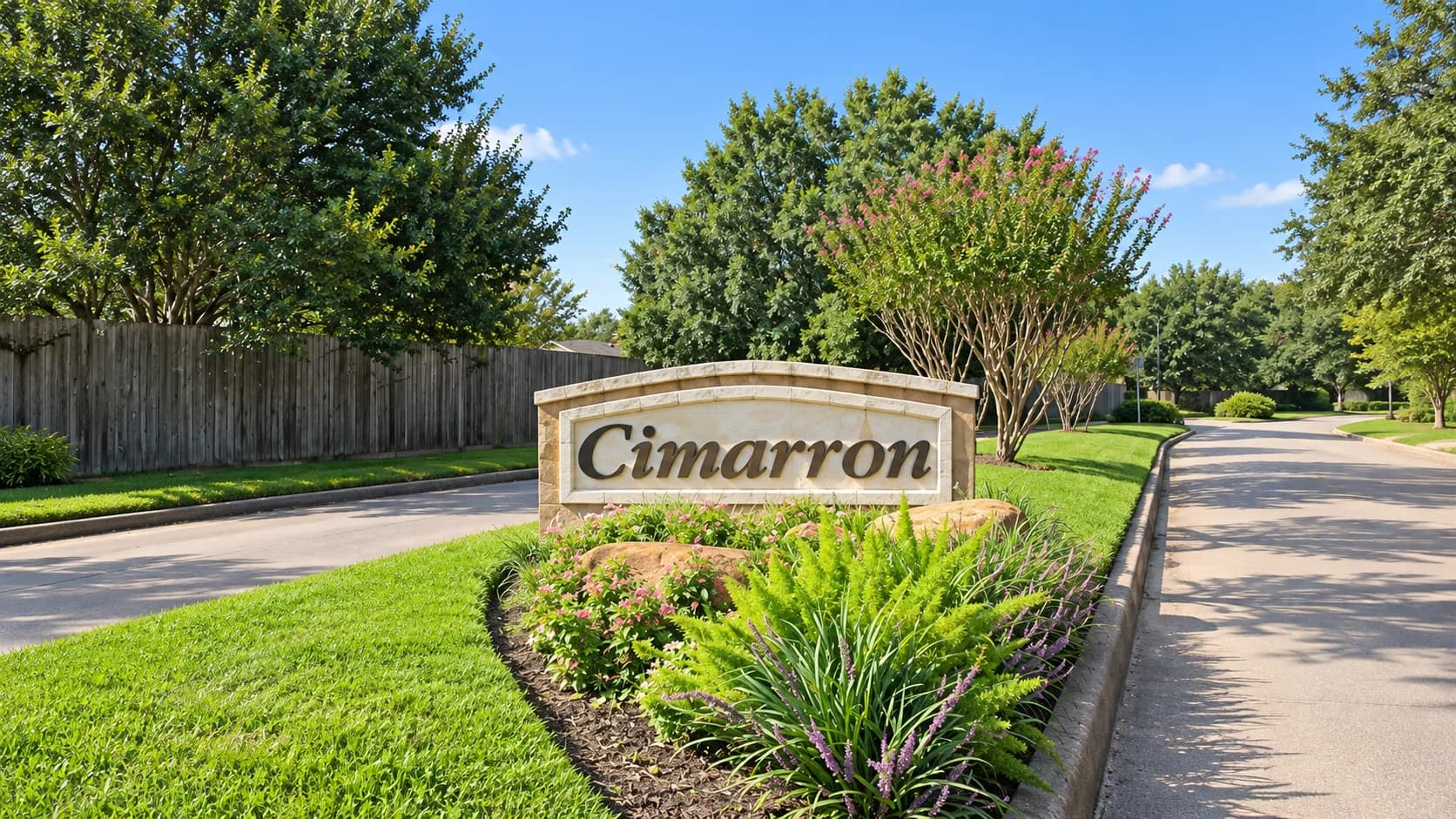 Cimarron community monument sign along a tree-lined neighborhood street